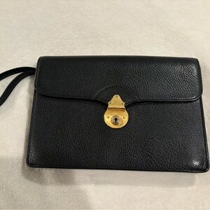 Vintage Burberry black leather clutch bag with a gold-tone push-lock closure